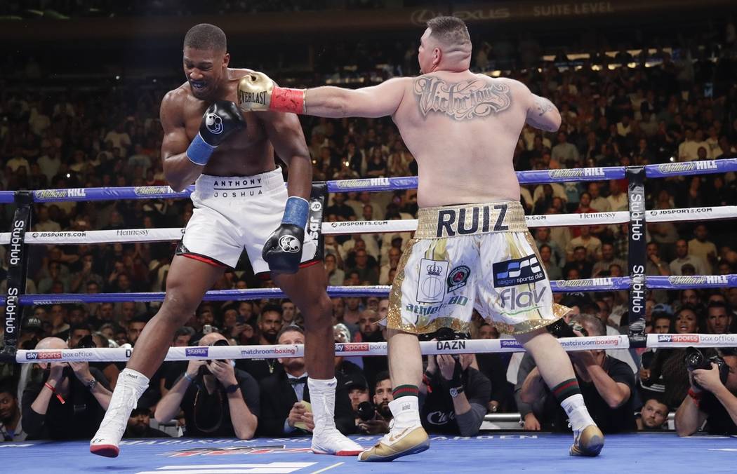 Andy Ruiz, right, punches Anthony Joshua during the third round of a heavyweight title boxing m ...