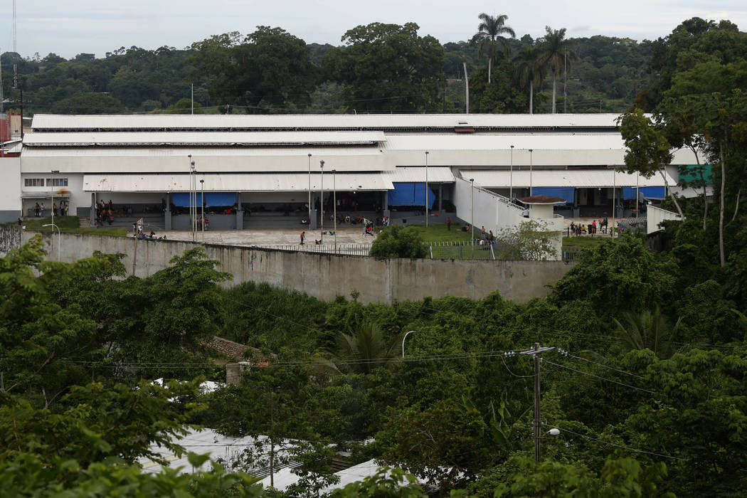 Migrants mill about in a courtyard at a migrant detention center in Tapachula, Mexico, Saturday ...