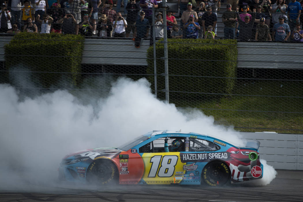 Kyle Busch celebrates after winning a NASCAR Cup Series auto race at Pocono Raceway, Sunday, Ju ...