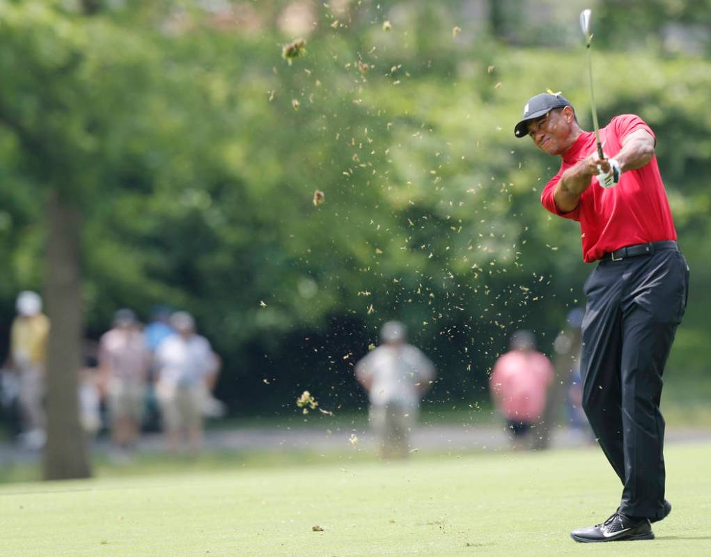 Tiger Woods hits his approach shot on the second hole during the final round of the Memorial go ...
