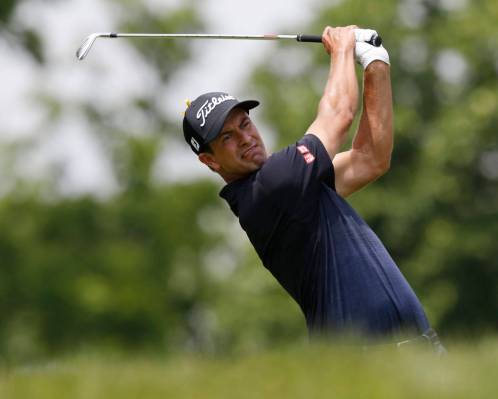 Adam Scott, of Australia, tees off on the third hole during the final round of the Memorial gol ...