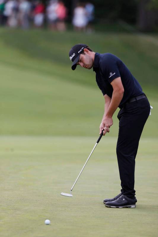 Patrick Cantlay putts on the first hole during the final round of the Memorial golf tournament ...