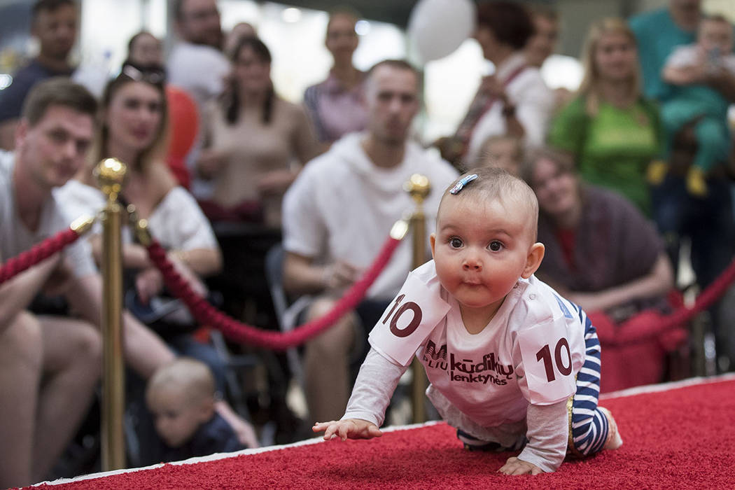 A baby crawls during the Baby Race event to mark international Children's Day in Vilnius, Lithu ...