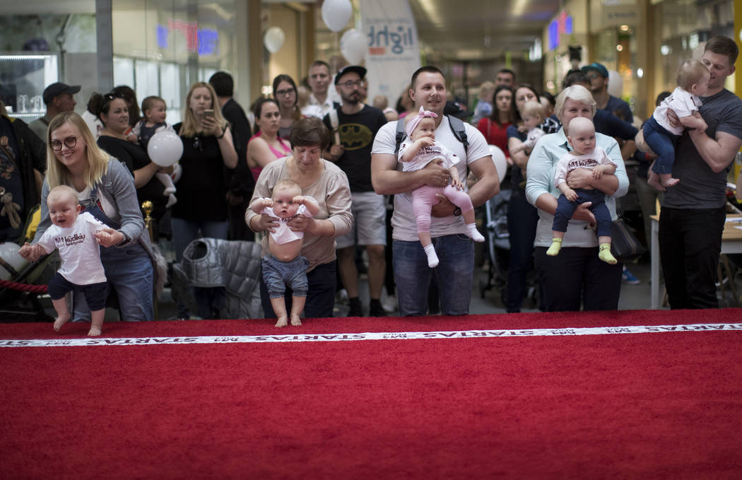 Parents prepare to release their babies during the Baby Race event to mark international Childr ...