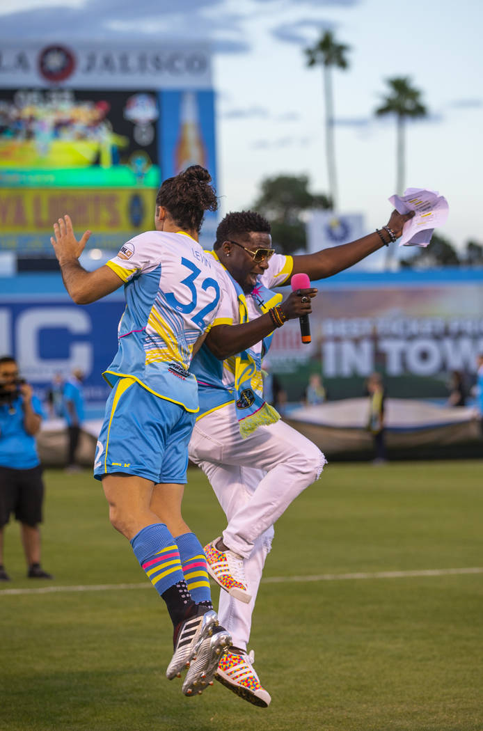 Las Vegas Lights FC defender Jonathan Levin (32) and hype man Robert "Bojo" Ackah bump in the a ...