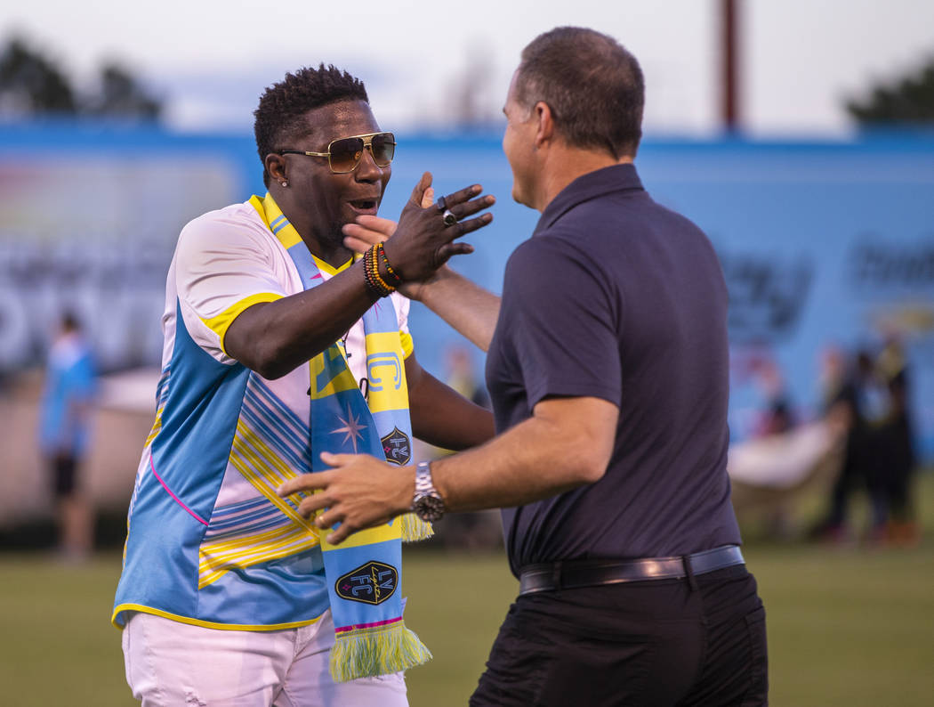 Las Vegas Lights FC head coach Eric Wynalda and hype man Robert "Bojo" Ackah greet each other d ...