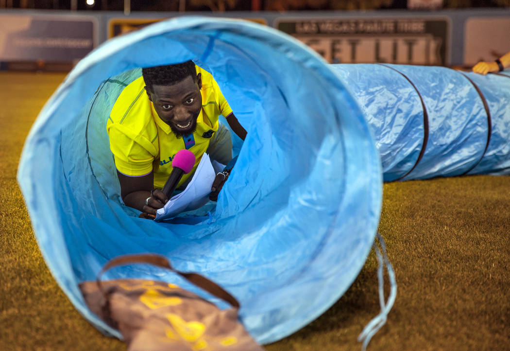 Las Vegas Lights FC hype man Robert "Bojo" Ackah navigates a plastic pip used for a dog obstacl ...