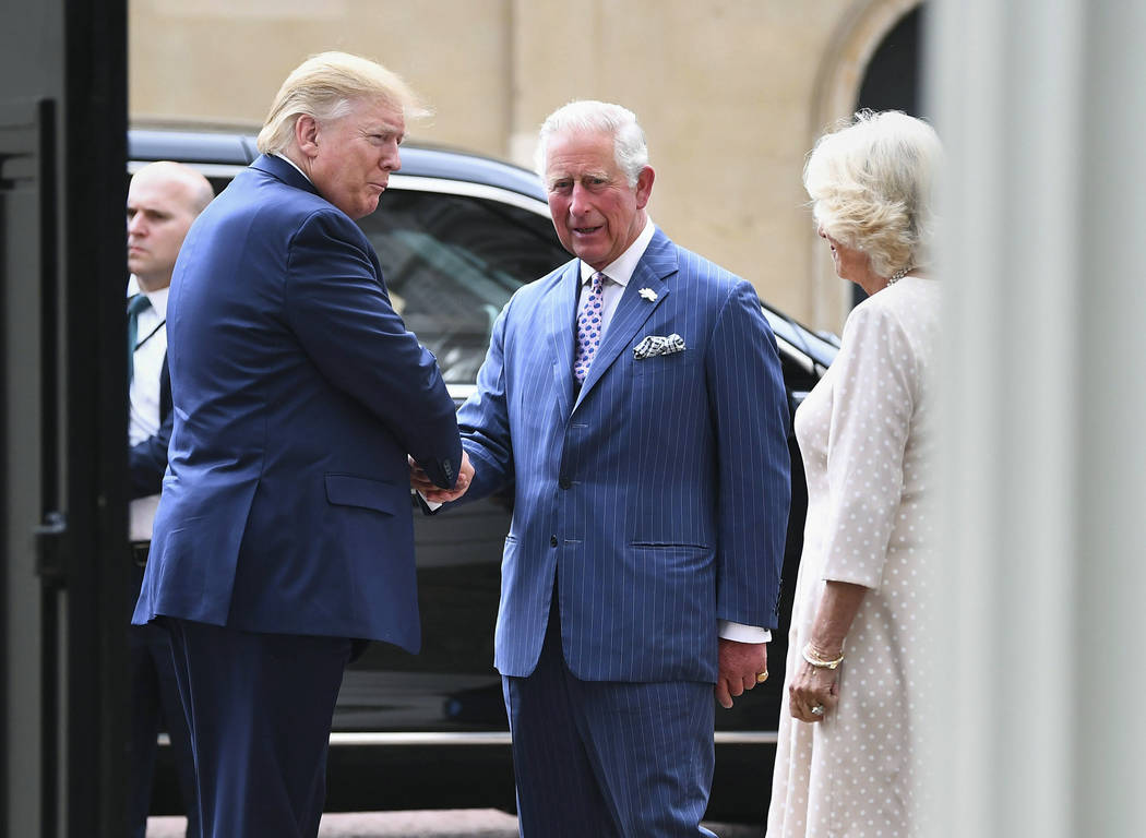 US President Donald Trump, left, is greeted by Britain's Prince Charles and Camilla, the Duche ...