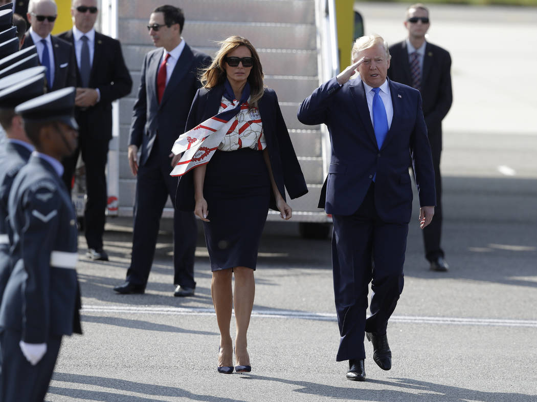 President Donald Trump salutes an honor guard as he and first lady Melania Trump arrive at Stan ...