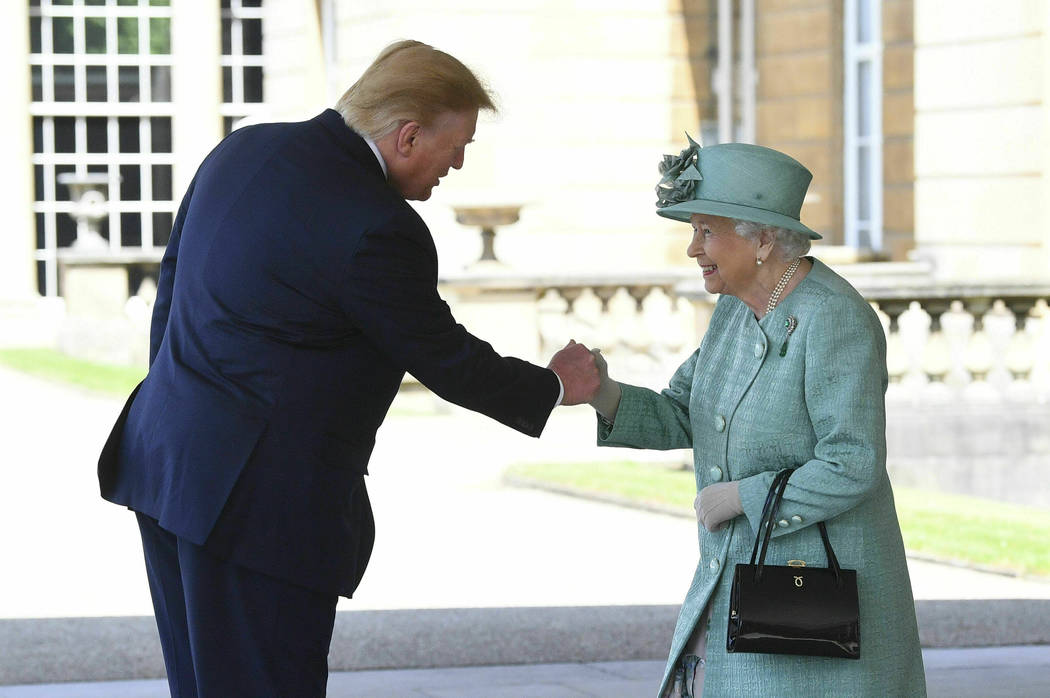 Britain's Queen Elizabeth II greets President Donald Trump as he arrives for a welcome ceremony ...