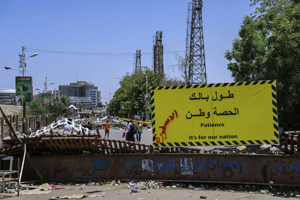 FILE - In this May 14, 2019, file photo, protesters pass makeshift barricades on their way to t ...