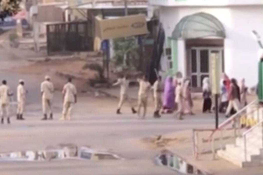 In this image made from video, Sudanese forces escort civilian in Khartoum, Sudan on Monday, Ju ...