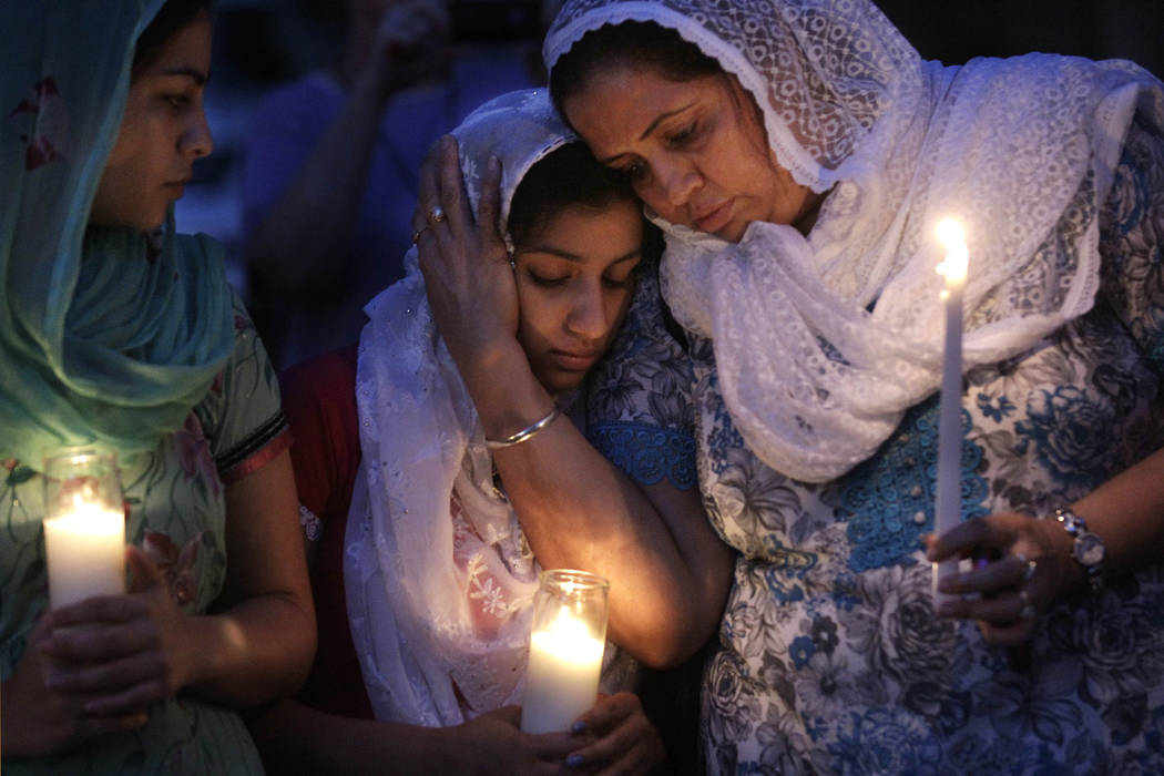 FILE - In this Monday, Aug. 6, 2012 file photo, Sikh worshipers gather for a candlelight vigil ...