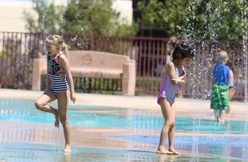Maye Spann, 6, left, and her friend Stella Huang, 7, play at Paseo Vista Park on Monday, June, ...