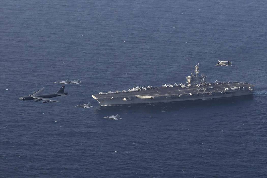 The USS Abraham Lincoln carrier and a U.S. Air Force B-52H Stratofortress, conduct joint exerci ...