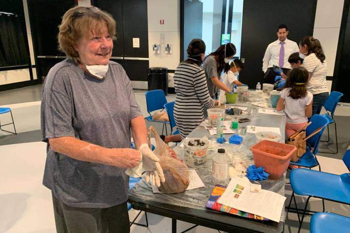 Susan Greene, 69, an attendee at the hypertufa pot making event, prepares to cleanup after crea ...