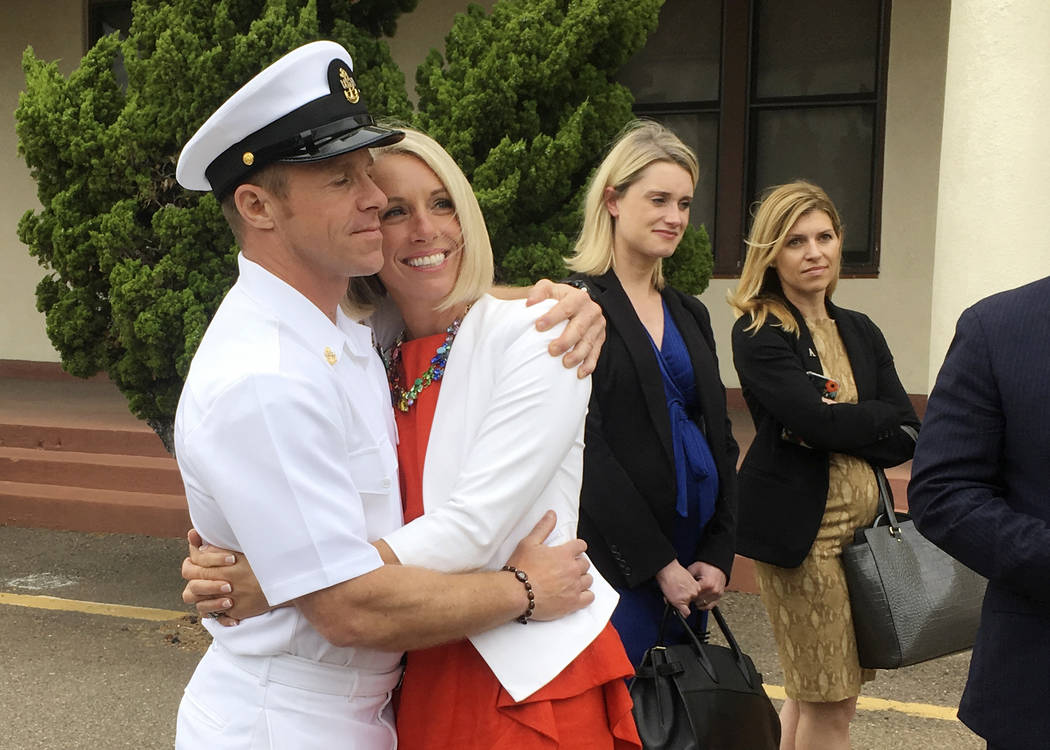 Navy Special Operations Chief Edward Gallagher, left, hugs his wife, Andrea Gallagher, after le ...