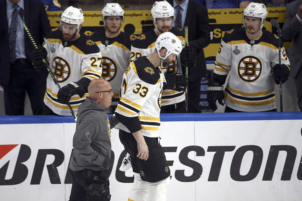 Boston Bruins defenseman Zdeno Chara (33), of Slovakia, leaves the ice after being hit in the f ...