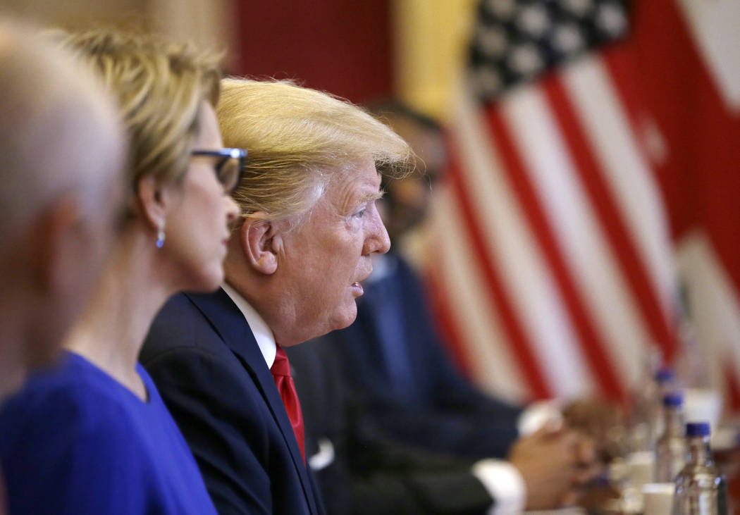 U.S President Donald Trump attends a business roundtable event with British Prime Minister Ther ...