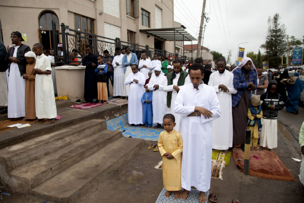 Kenyan Muslims stand for prayers outside Masjid As Salaam during the Eid al-Fitr prayers in Nai ...