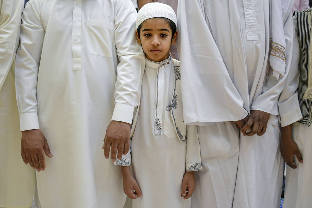 A boy attends Eid al-Fitr prayers in Bucharest, Romania, Tuesday, June 4, 2019. Members of the ...