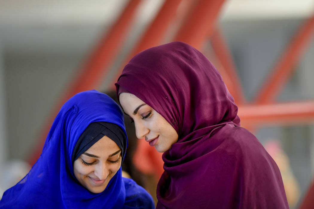 Girls wait for the start of Eid al-Fitr prayers in Bucharest, Romania, Tuesday, June 4, 2019. M ...