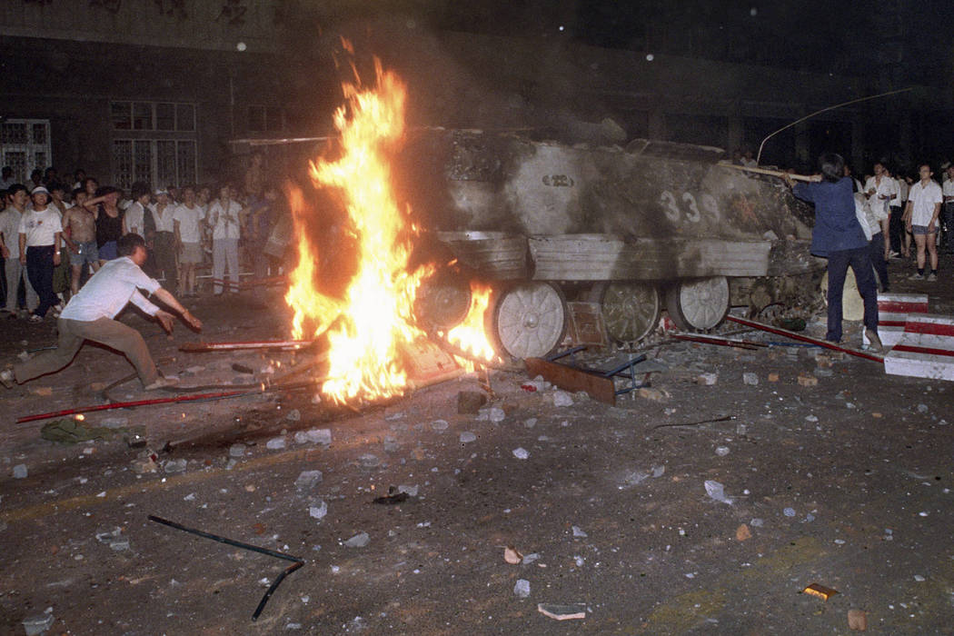 In the early hours of June 4, 1989, a student protester puts barricades in the path of an alrea ...