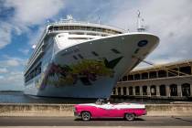 In this July 3, 2018 photo, a privately licensed taxi driver drives his classic convertible car ...