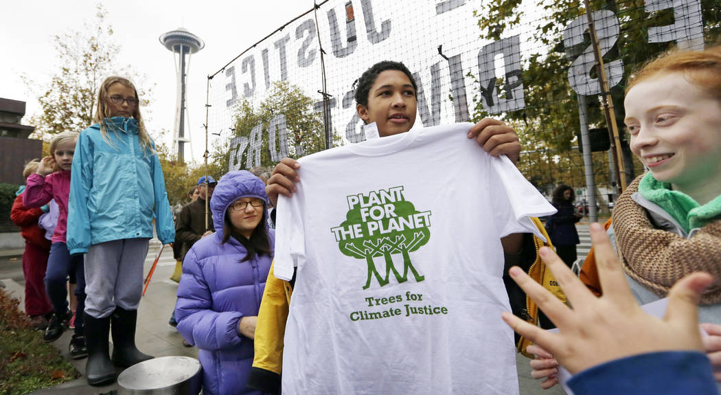 FILE - In this Oct. 28, 2015, file photo, teenage environmental activist Aji Piper holds up a s ...