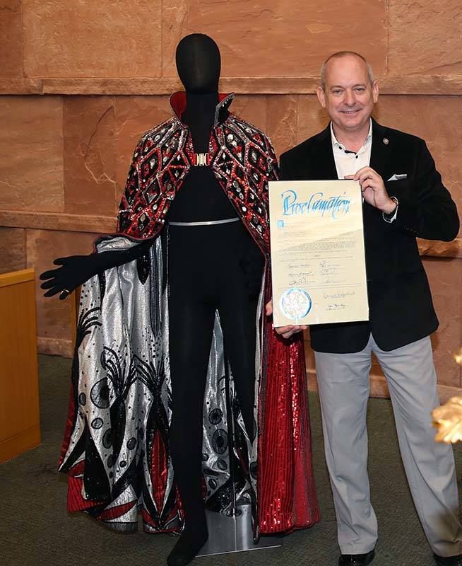 Jonathan Warren, chairman and CEO the Liberace Foundation, poses for a photo between Liberace's ...