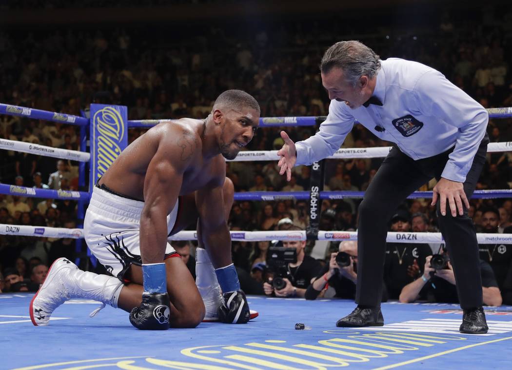 Anthony Joshua waits during the referee's count after he was knocked down during the seventh ro ...