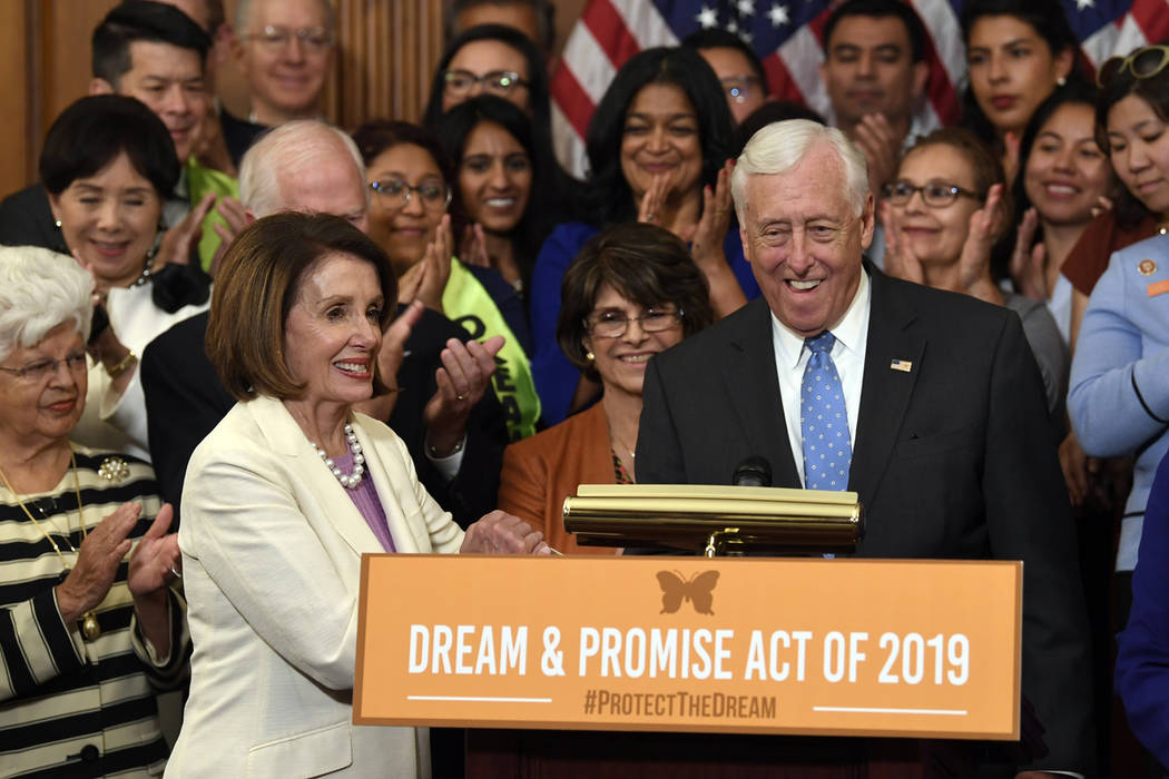 House Speaker Nancy Pelosi of Calif., front left, shakes hands with House Minority Whip Steny H ...