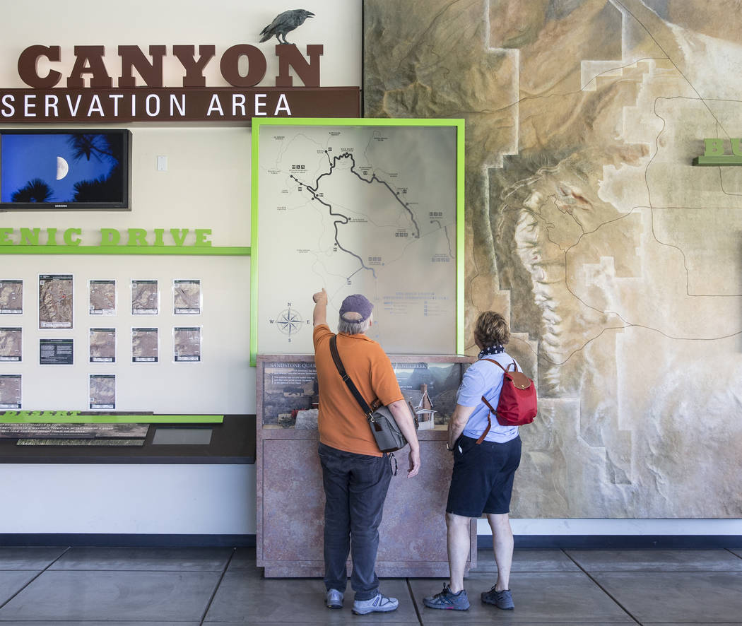 A couple looks over a map at the visitor center during "National Get Outdoors Day" at ...