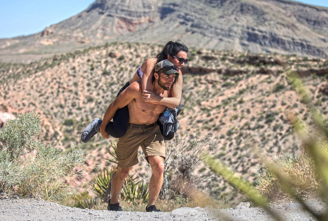 Seth Davidson carries Raises Barreto up a hill during "National Get Outdoors Day" at ...