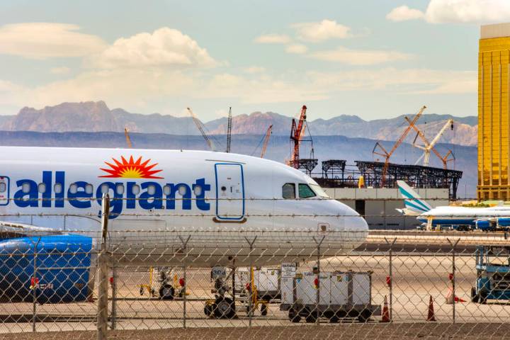 An Allegiant Air plane sits on the tarmac at McCarran International Airport in Las Vegas with t ...