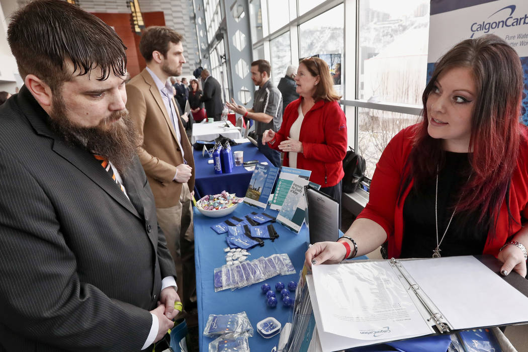 In a March 7, 2019, file photo visitors to the Pittsburgh veterans job fair meet with recruiter ...