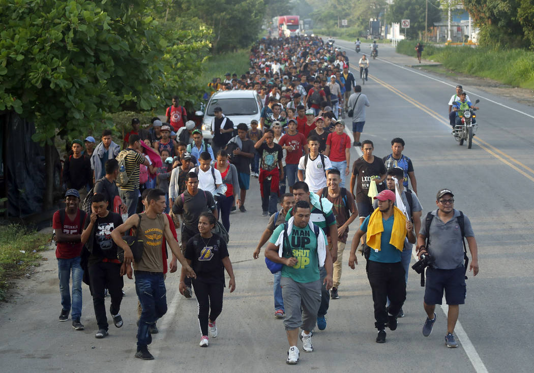 Hundreds of Central American migrants walk on the highway, after crossing the Guatemala &#x2013 ...