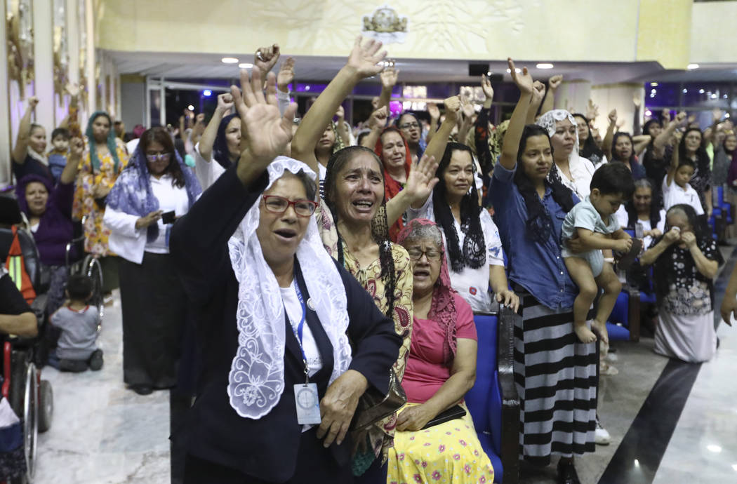 ADDS FIRST NAME - Women pray inside the "La Luz Del Mundo" or Light of the World chur ...