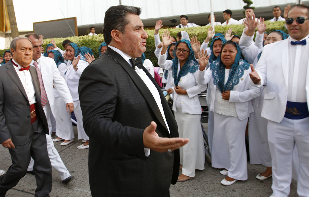 In an Aug. 14, 2018 photo, Naasón Joaquín García greets members of his church "La Luz del Mu ...