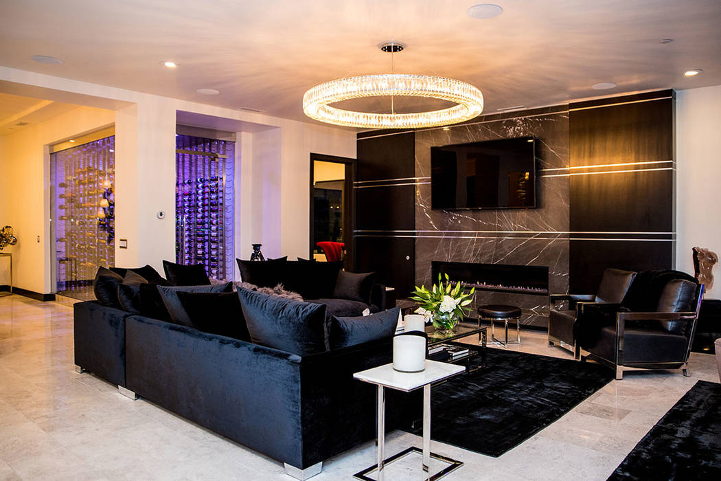 A sitting area in the living room is next to a wine wall. (Tonya Harvey Real Estate Millions)