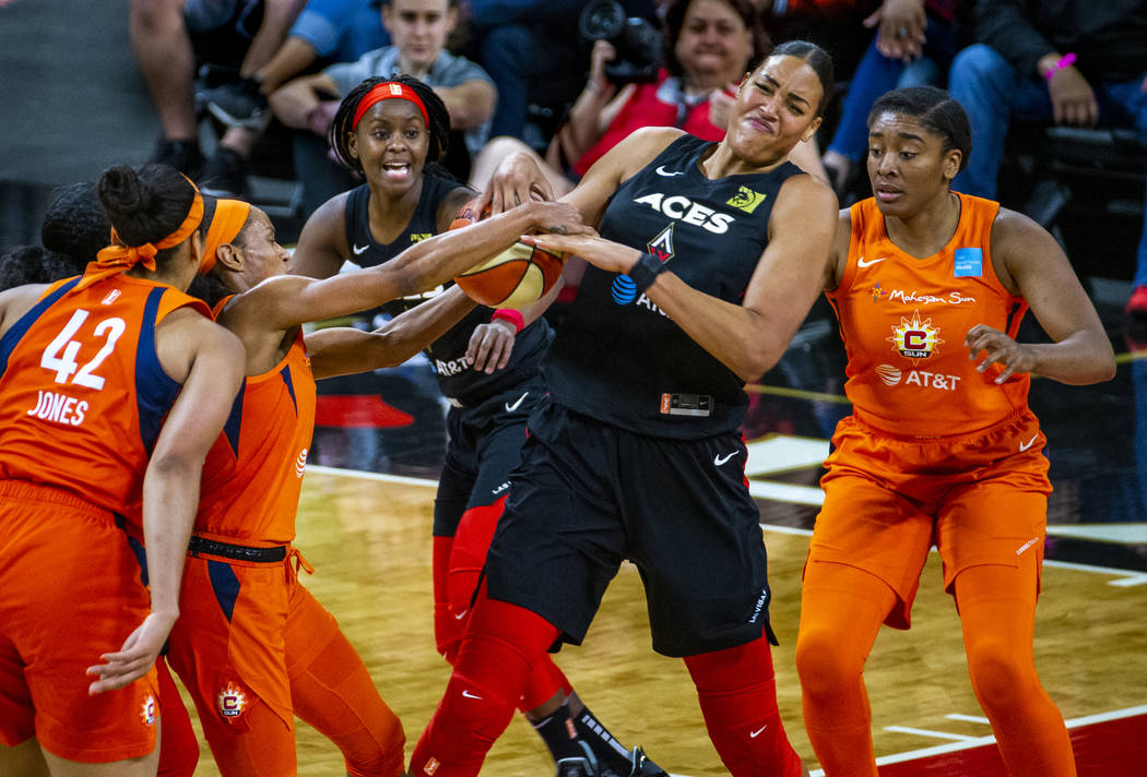 Las Vegas Aces center Liz Cambage (8) fights for the ball with Connecticut Sun guard Jasmine Th ...