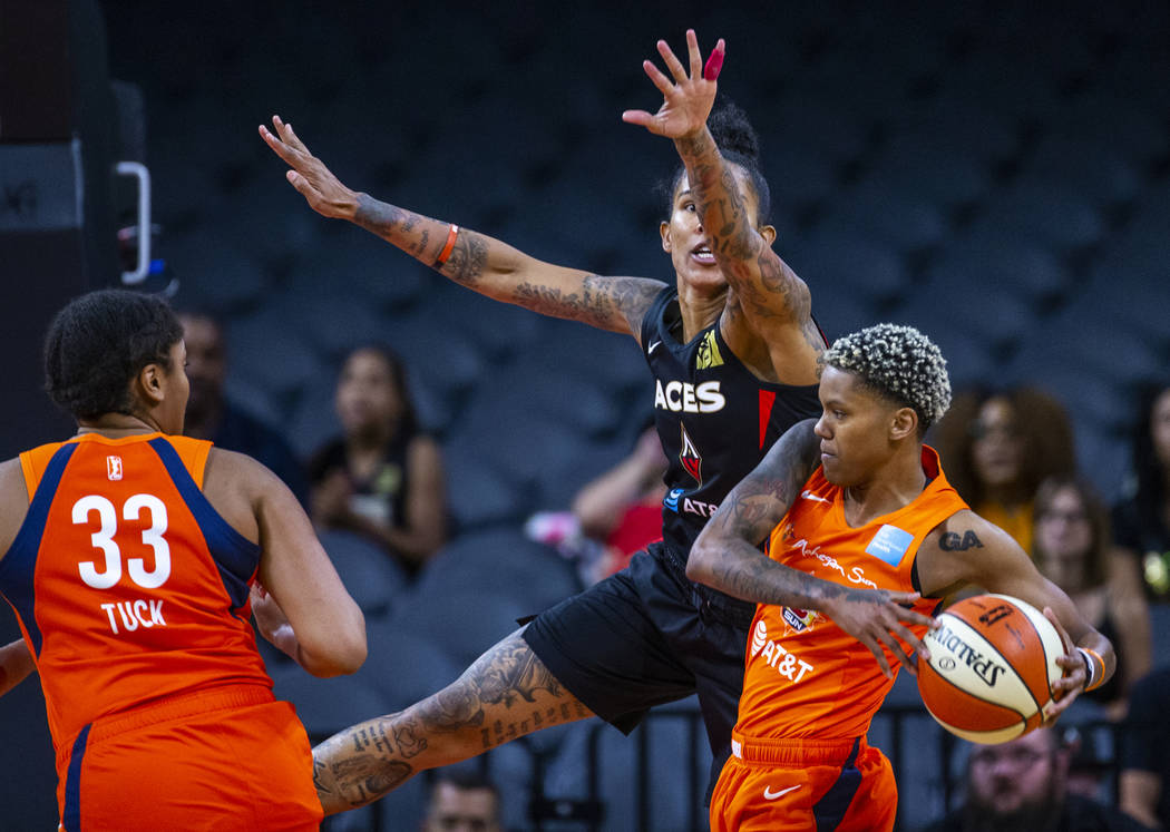 Las Vegas Aces forward Tamera Young (1) attempts to stop a pass attempt by Connecticut Sun guar ...
