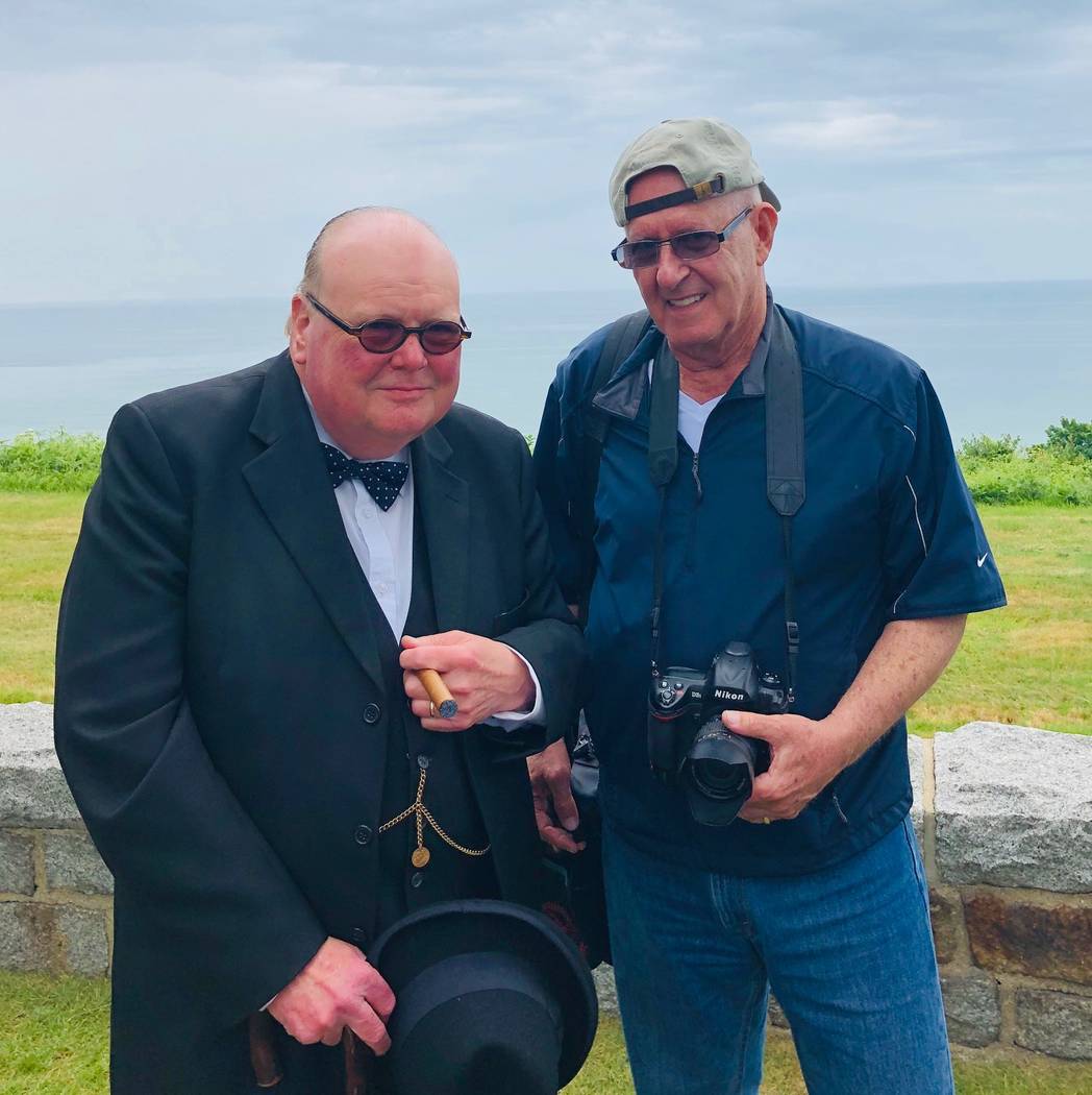 Barry Hartman, rights, stands with a Winston Churchill lookalike on Omaha Beach, Normandy, Fran ...