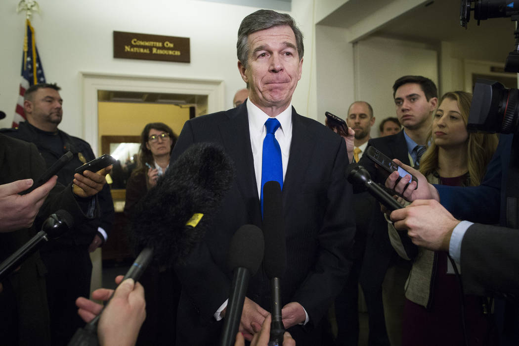 FILE - In a Feb. 6, 2019 file photo, North Carolina Gov. Roy Cooper speaks with reporters after ...