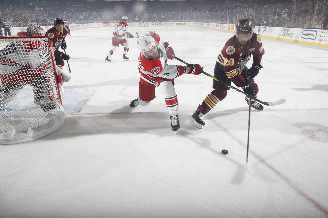 Chicago Wolves right wing Keegan Kolesar (20) and Charlotte Checkers defenseman Roland McKeown ...