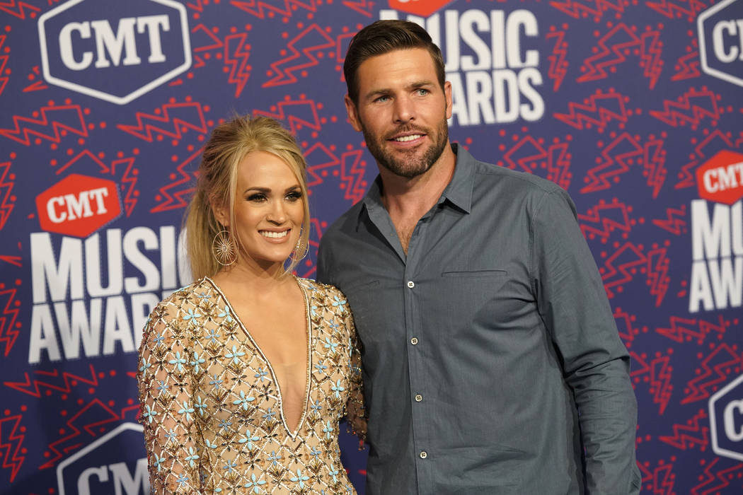 Carrie Underwood, left, and Mike Fisher arrive at the CMT Music Awards on Wednesday, June 5, 20 ...