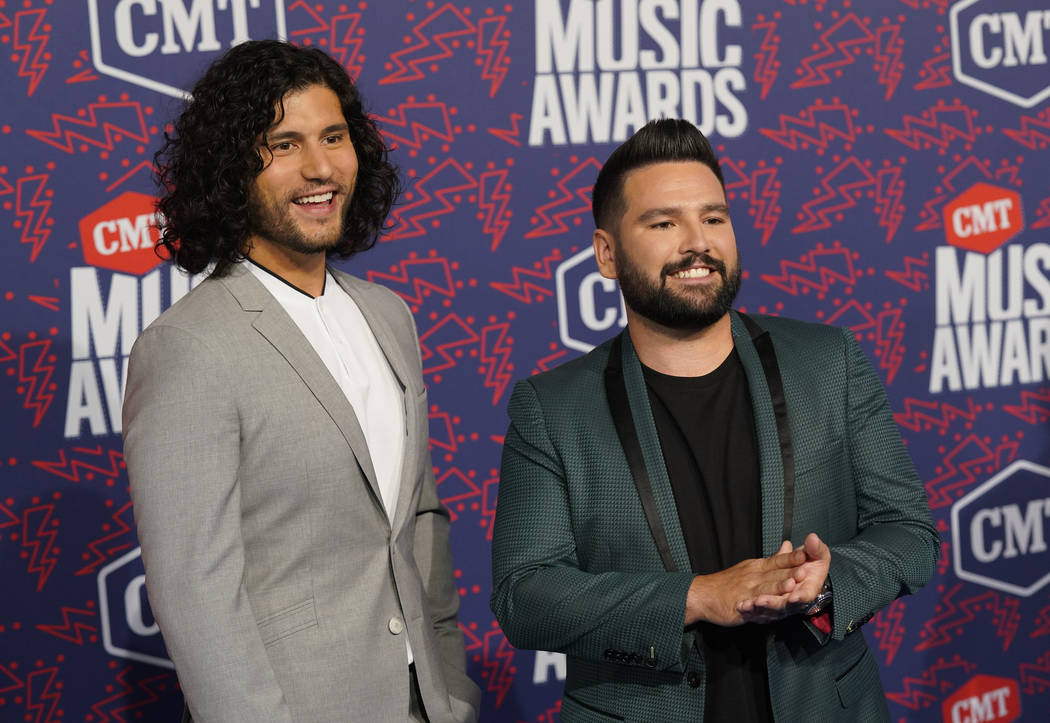 Dan Smyers, left, and Shay Mooney, of Dan + Shay, arrive at the CMT Music Awards on Wednesday, ...