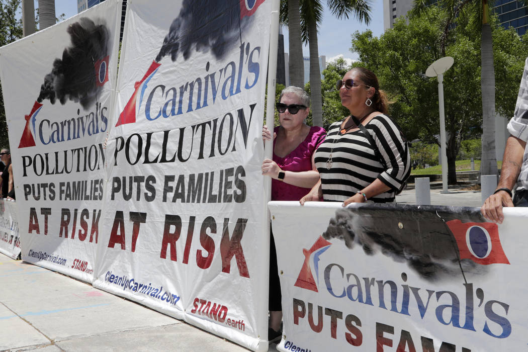 Protestors with Stand.earth hold a banner in opposition to Carnival Corp. outside of federal co ...