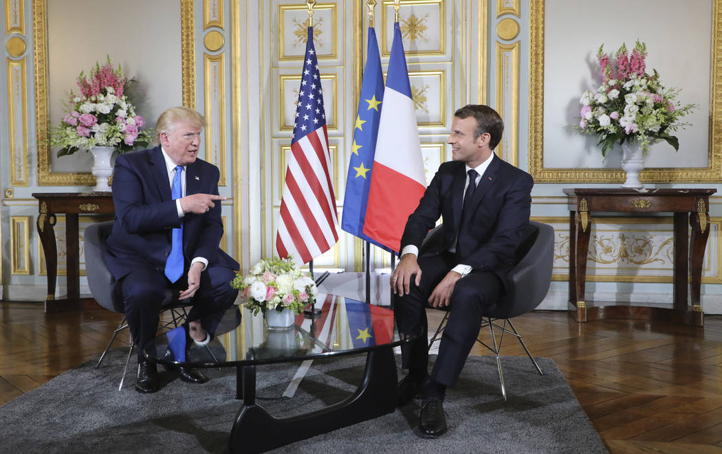 U.S President Donald Trump, left, talks to French President Emmanuel Macron during a meeting at ...