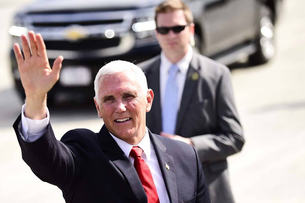 Vice President Mike Pence waves to the media after landing at the Roanoke-Blacksburg Regional A ...